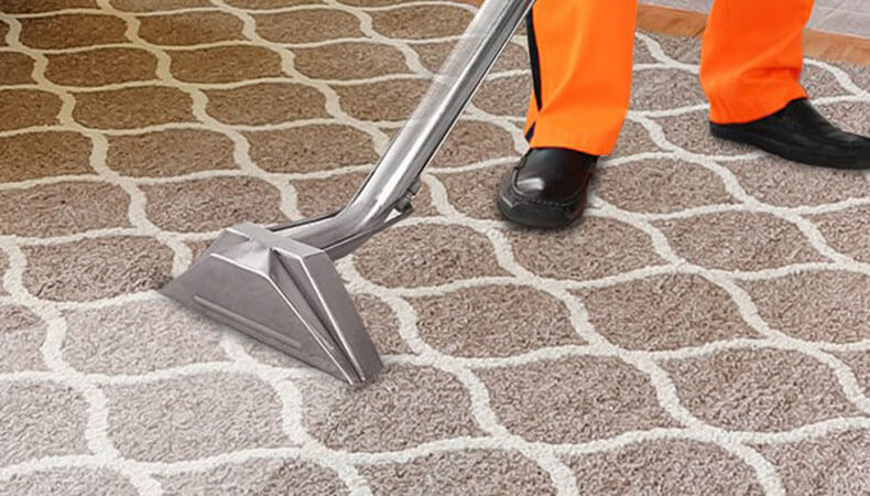 This image shows a man using a vacuum to clean a carpet