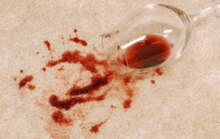 This image shows a spilled wine on a carpet.