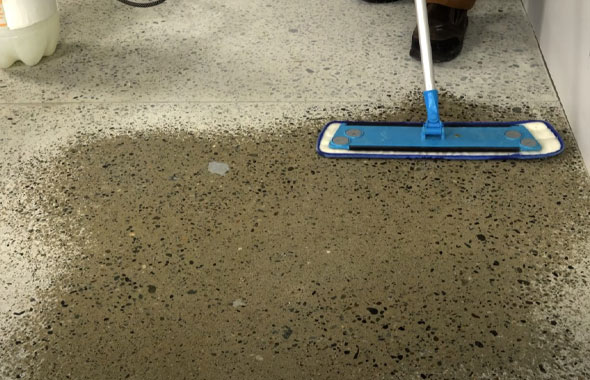 This image shows a man cleaning the floor.